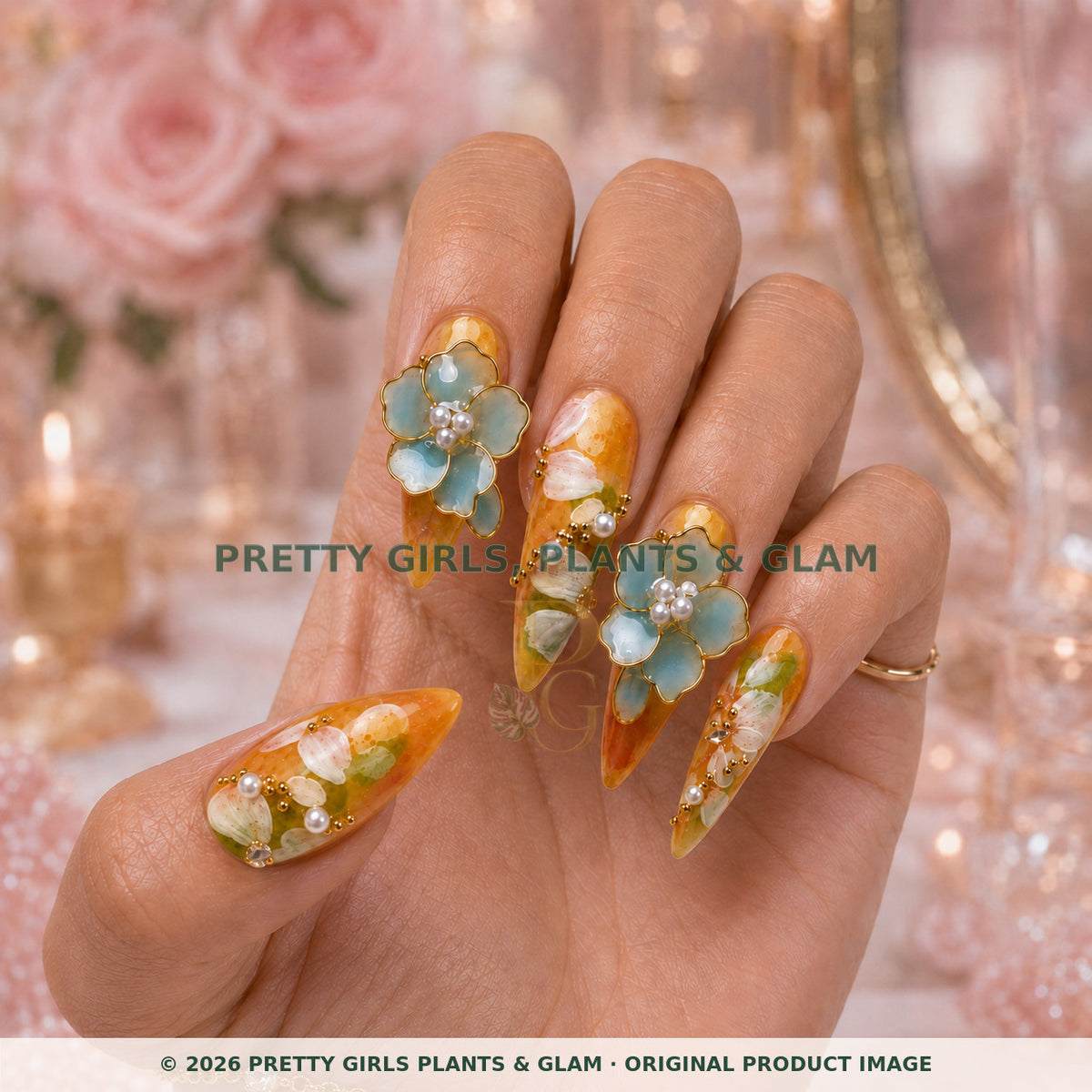 Amber Blossom press-on nails modeled upright on a hand