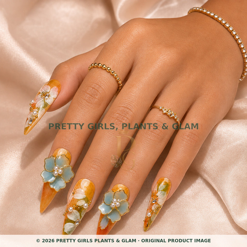 Amber Blossom press-on nails modeled on a hand