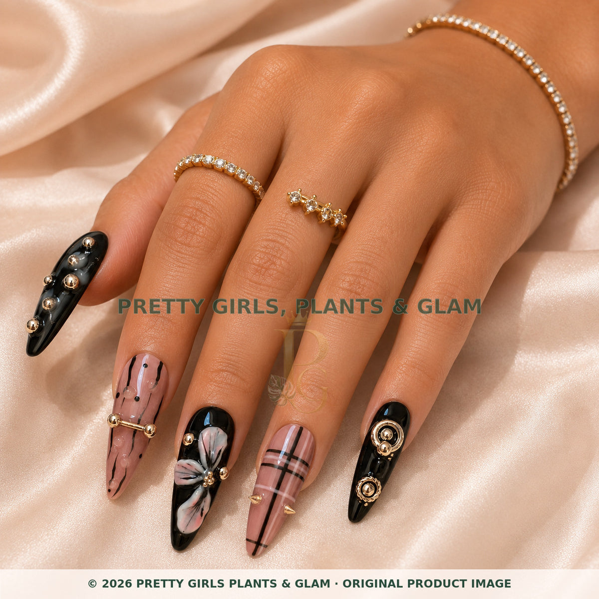 Blush Noir press-on nails modeled on a hand
