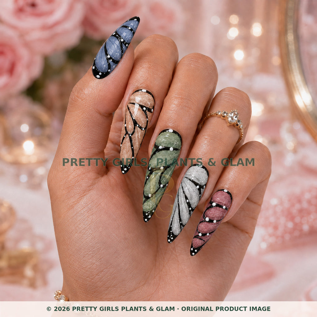 Butterfly Wings press-on nails modeled upright on a hand