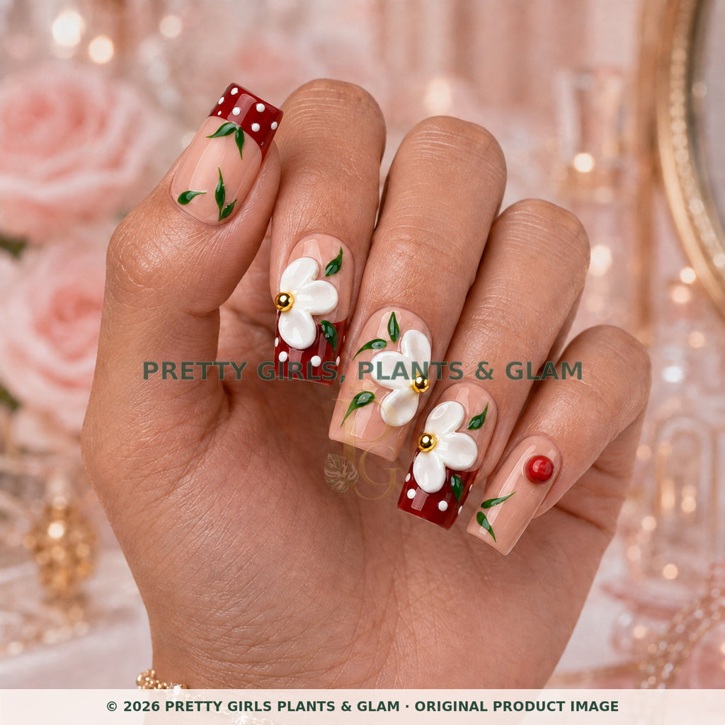Cherry Daisy press-on nails modeled upright on a hand