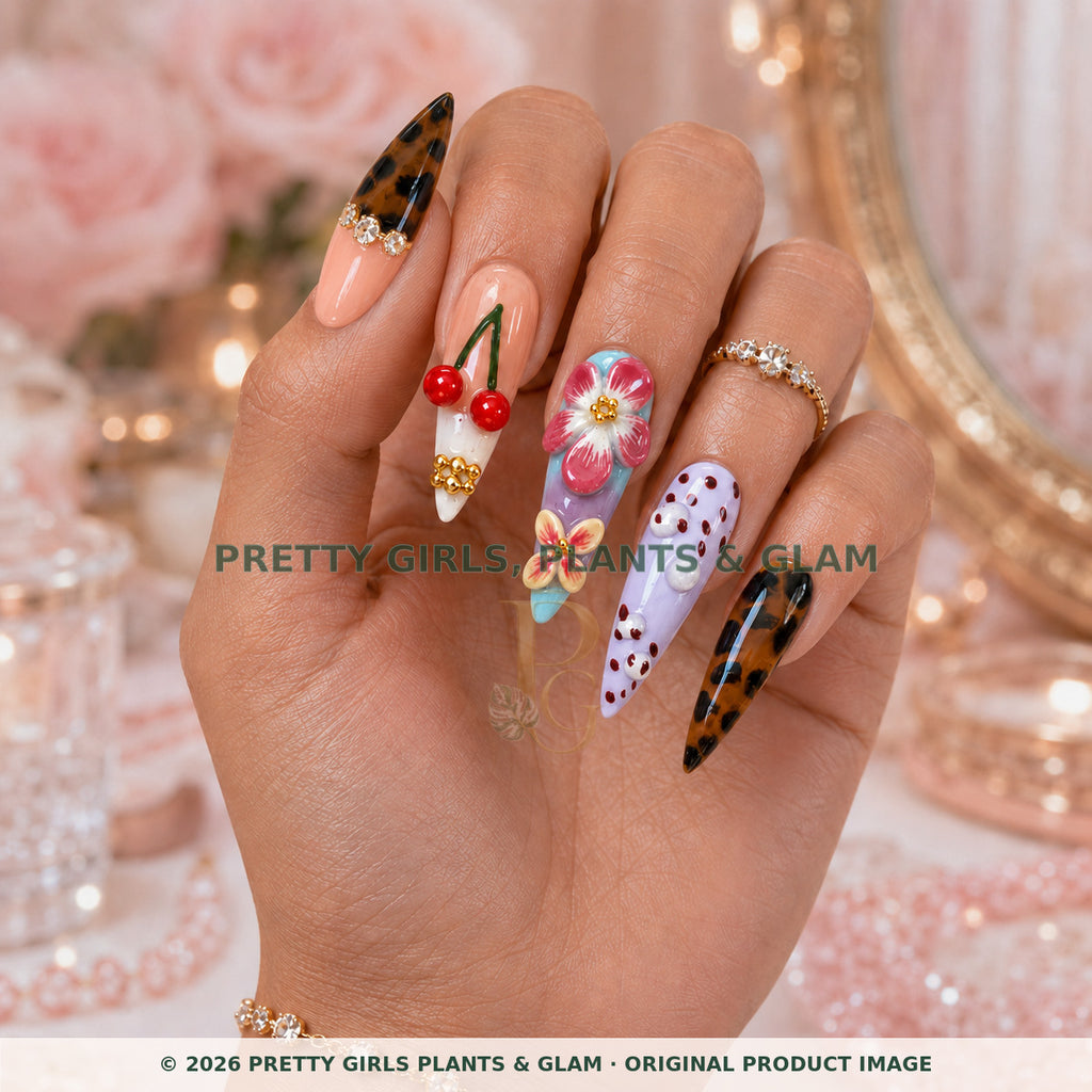 Cherry Muse press-on nails modeled upright on a hand