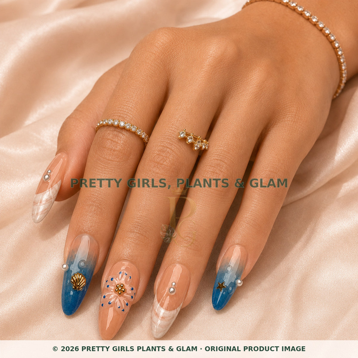 Coastal Bloom press-on nails modeled on a hand