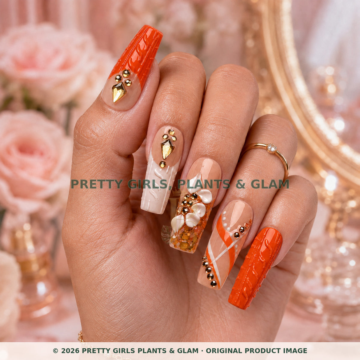 Coral Luxe press-on nails modeled upright on a hand