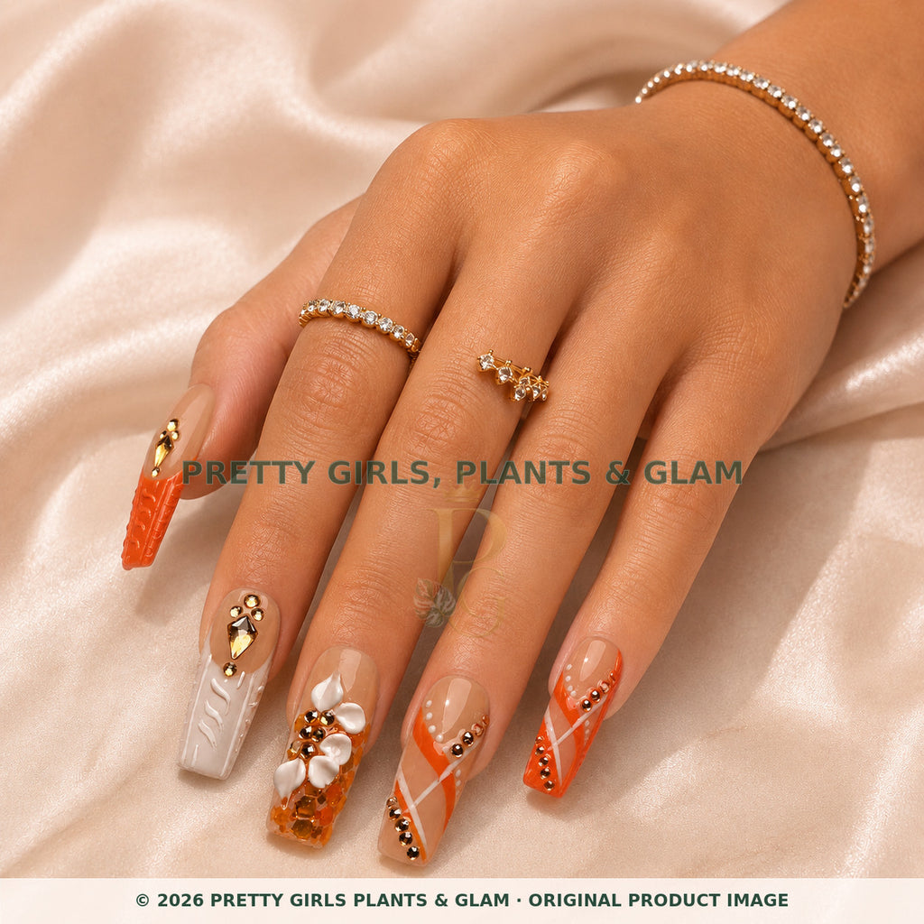 Coral Luxe press-on nails modeled on a hand