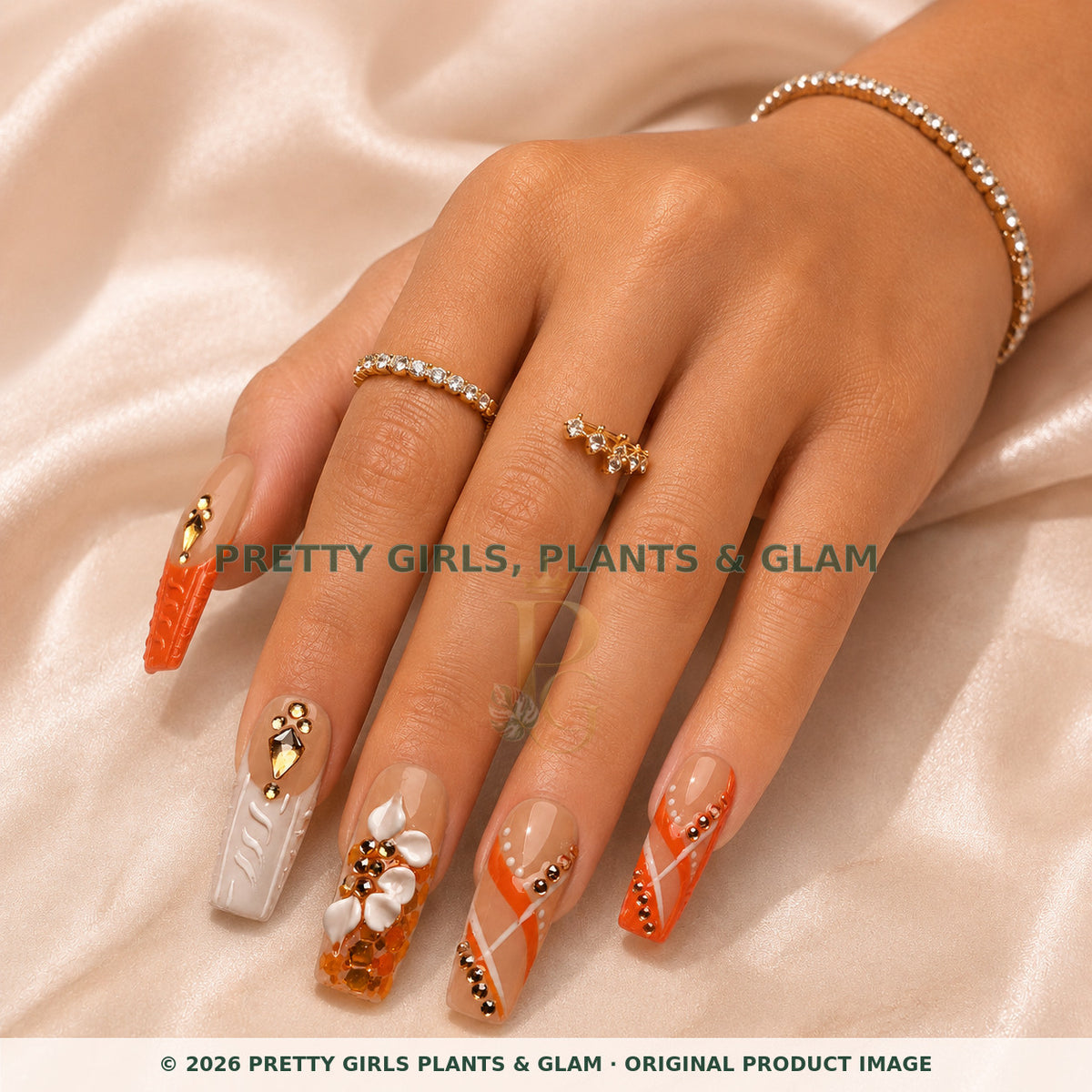 Coral Luxe press-on nails modeled on a hand