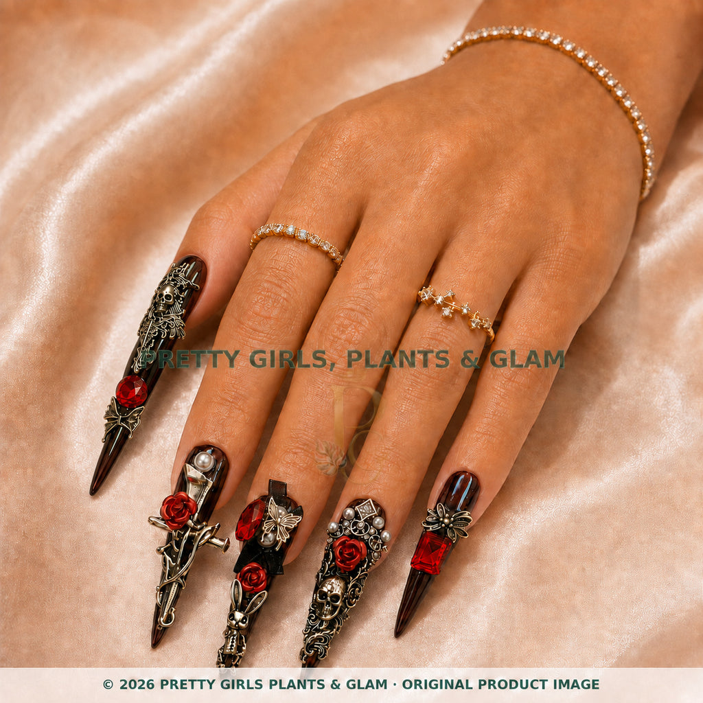 Crimson Romance press-on nails modeled on a hand