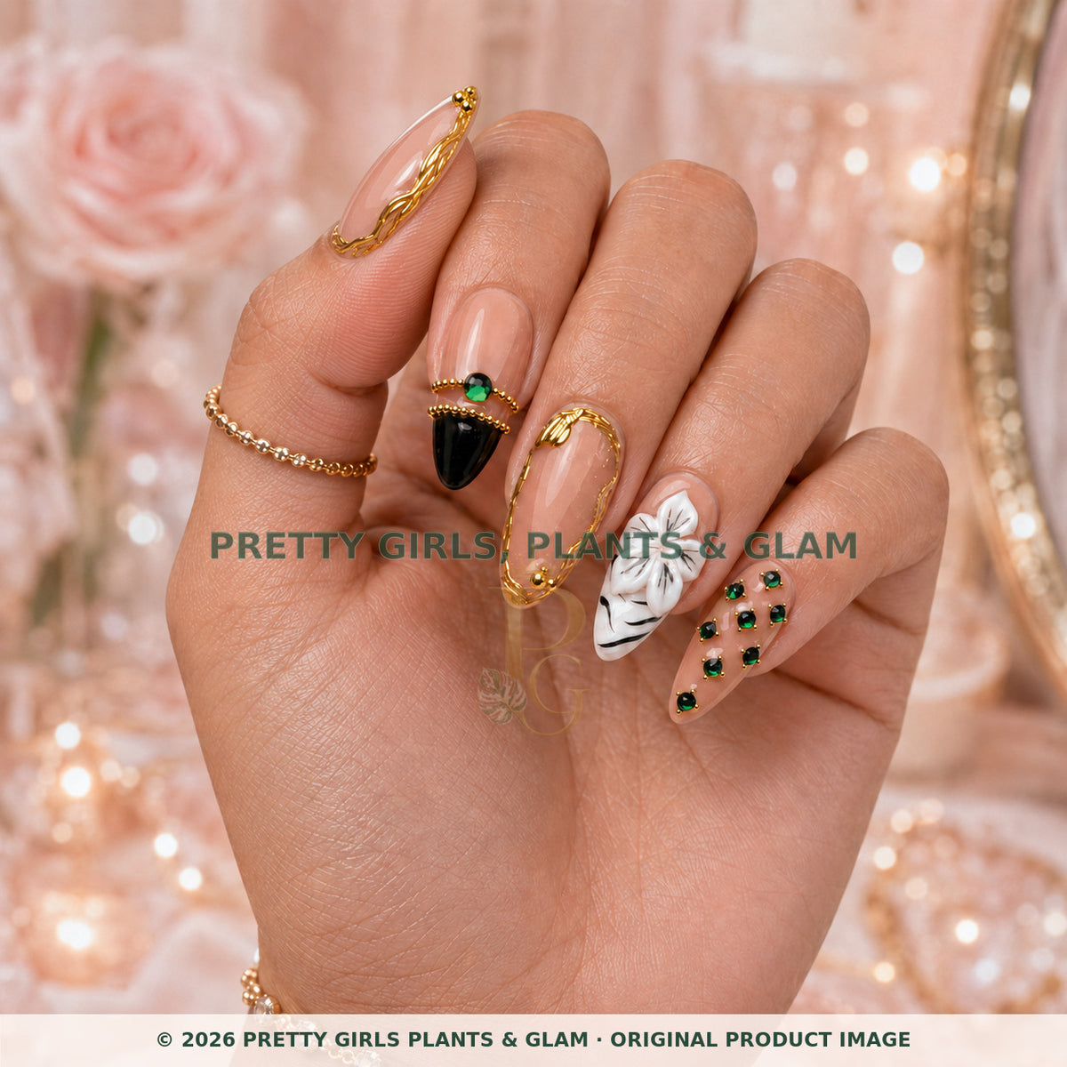 Emerald Crown Luxe press-on nails modeled upright on a hand