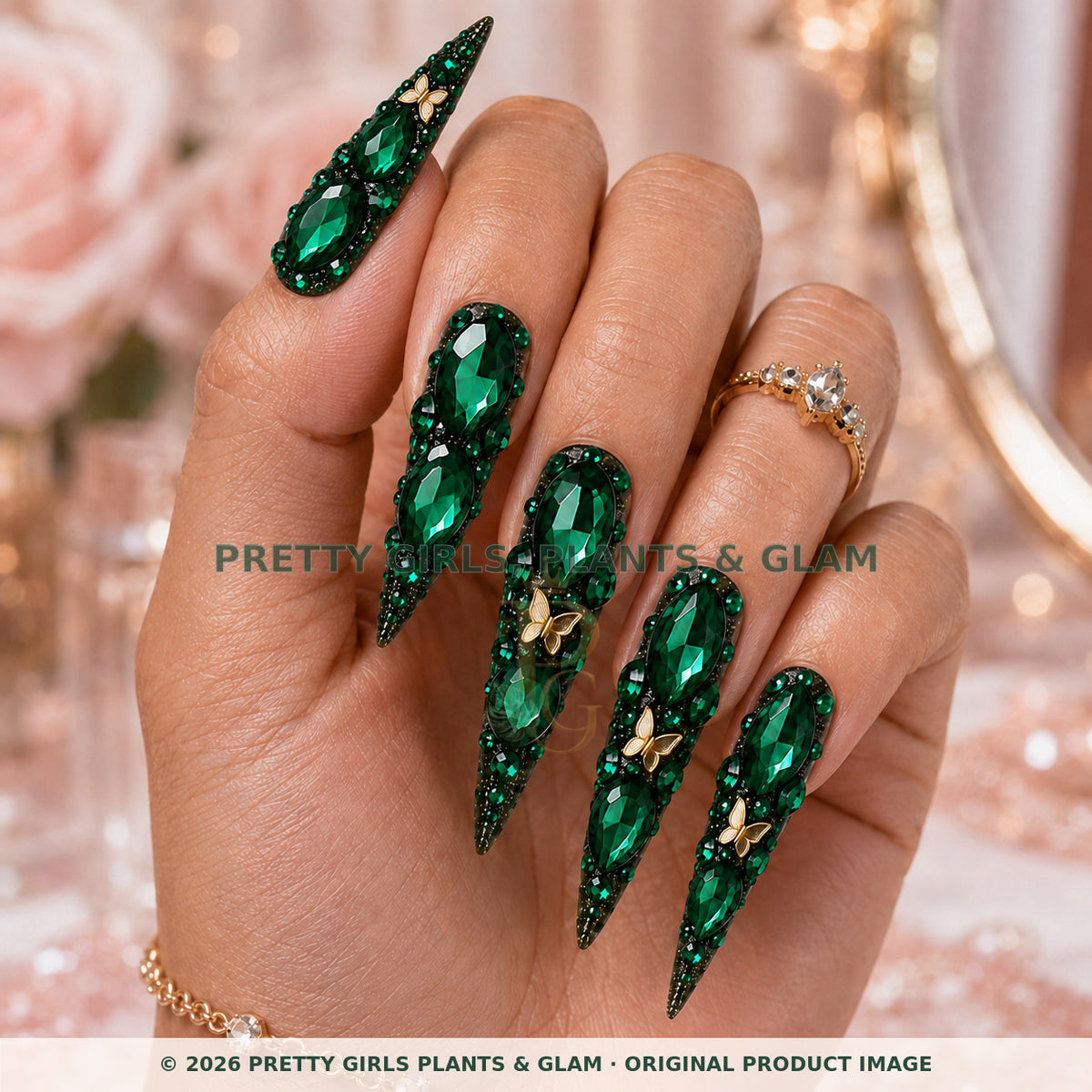 Emerald Secret press-on nails modeled upright on a hand