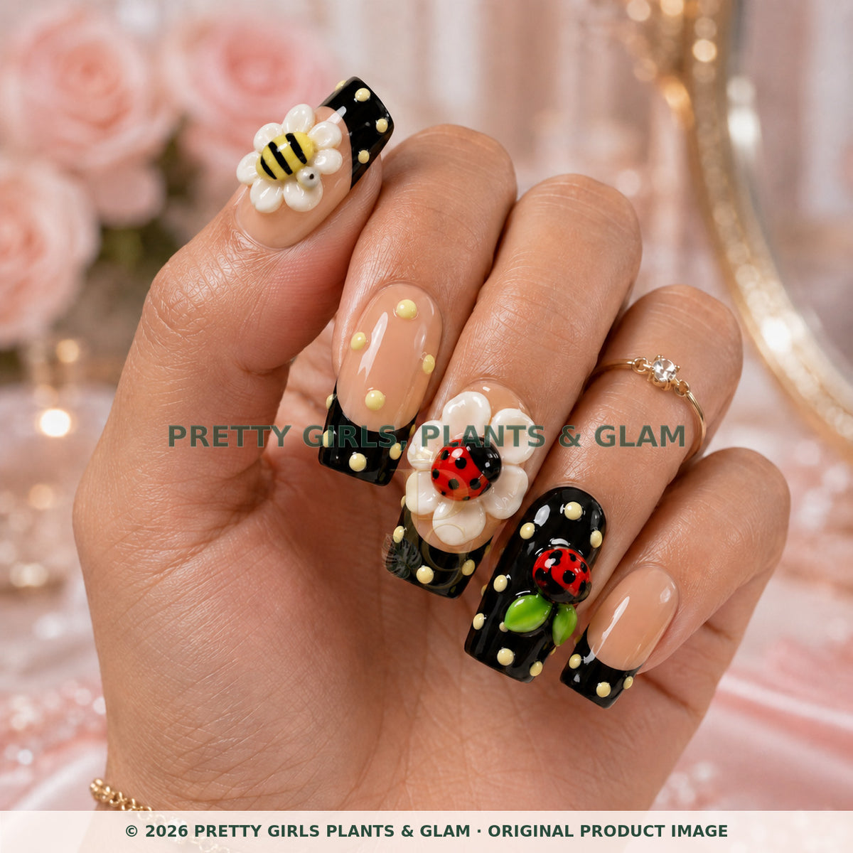 Garden Friends press-on nails modeled upright on a hand
