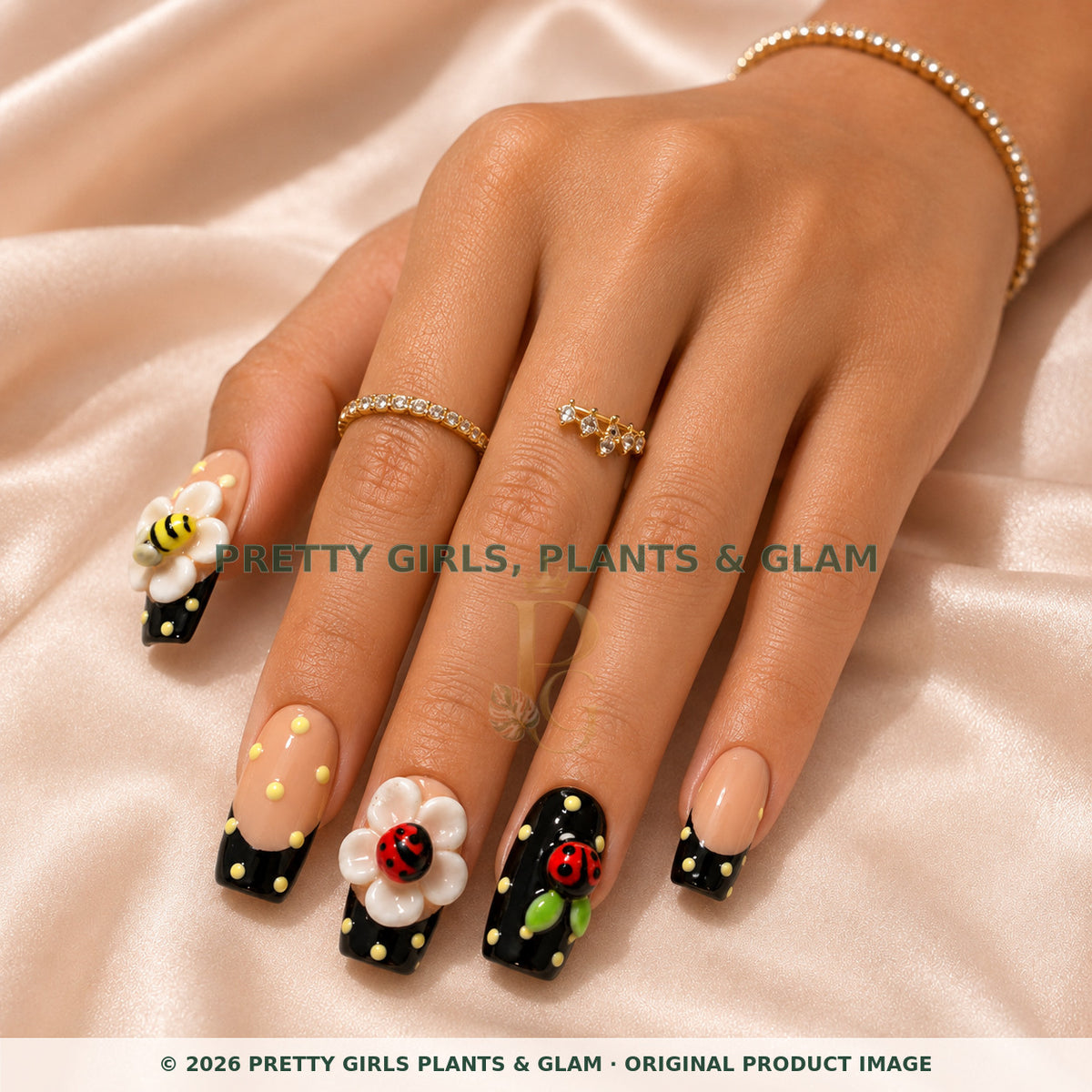 Garden Friends press-on nails modeled on a hand