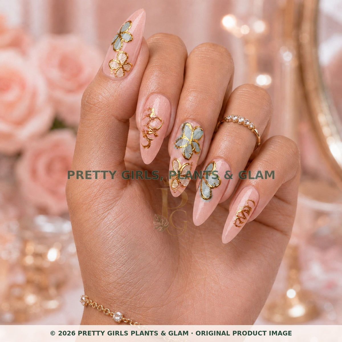 Gilded Butterfly Garden press-on nails modeled upright on a hand