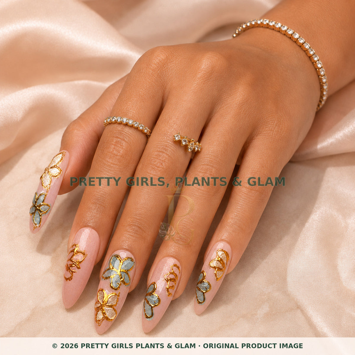 Gilded Butterfly Garden press-on nails modeled on a hand
