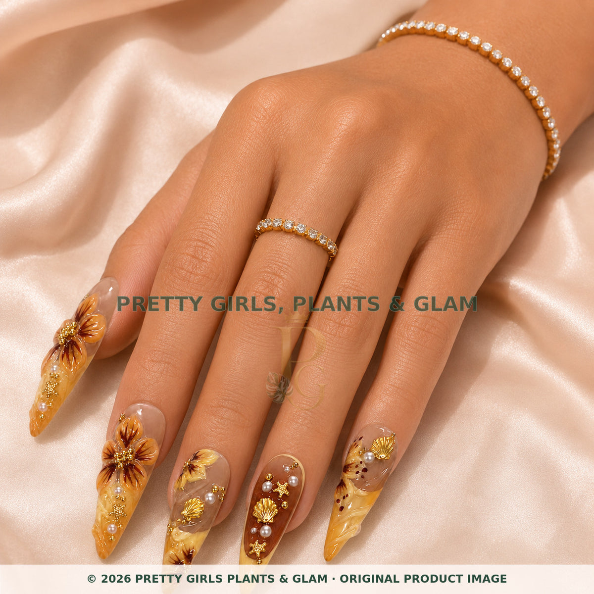 Golden Hour press-on nails modeled on a hand