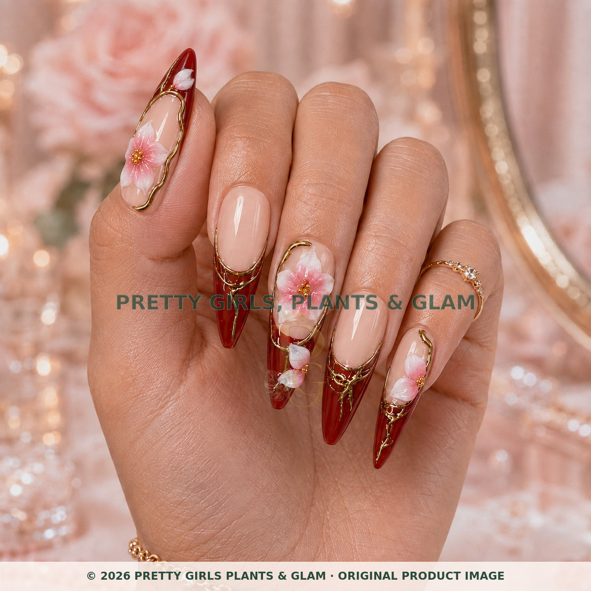 Merlot Bloom press-on nails modeled upright on a hand
