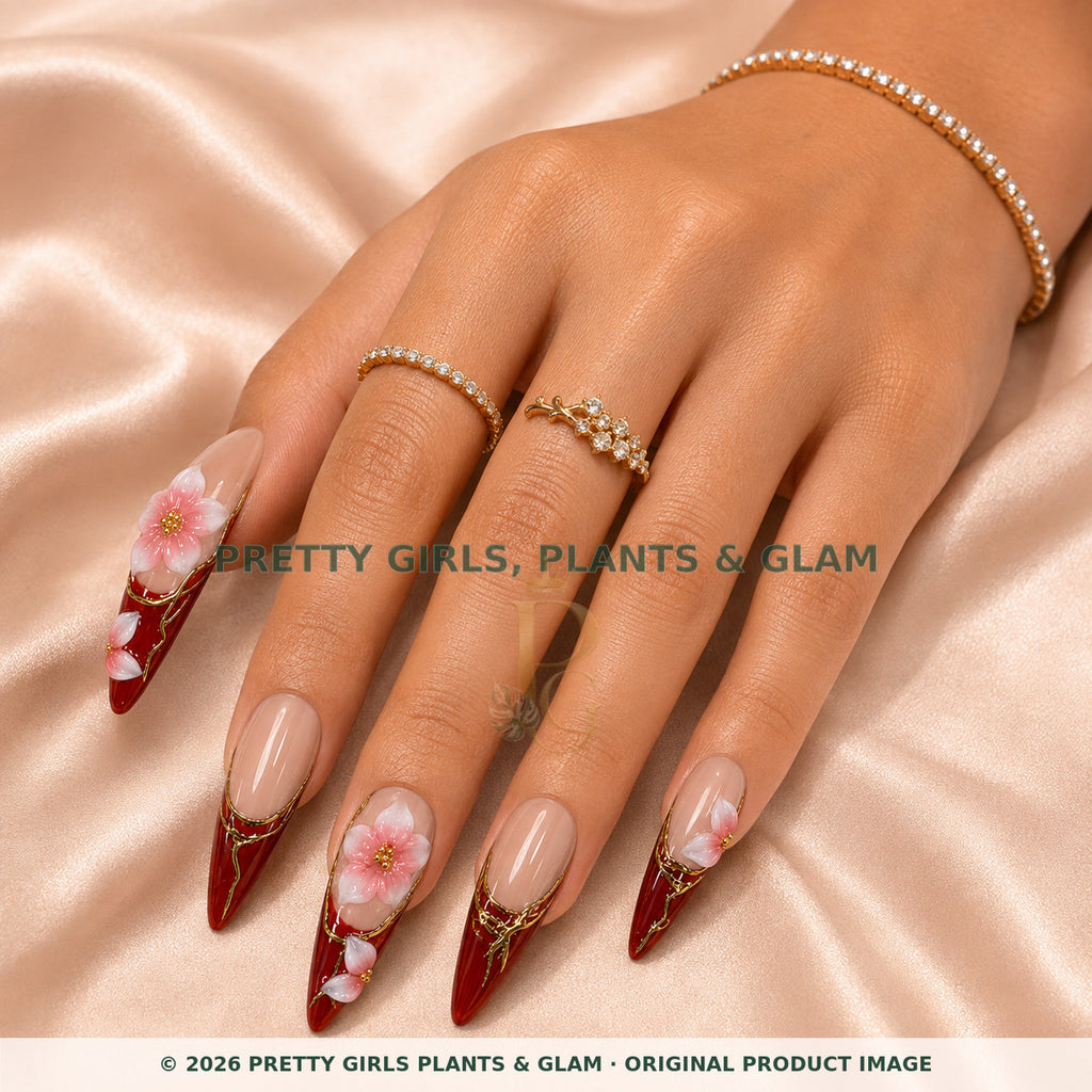 Merlot Bloom press-on nails modeled on a hand