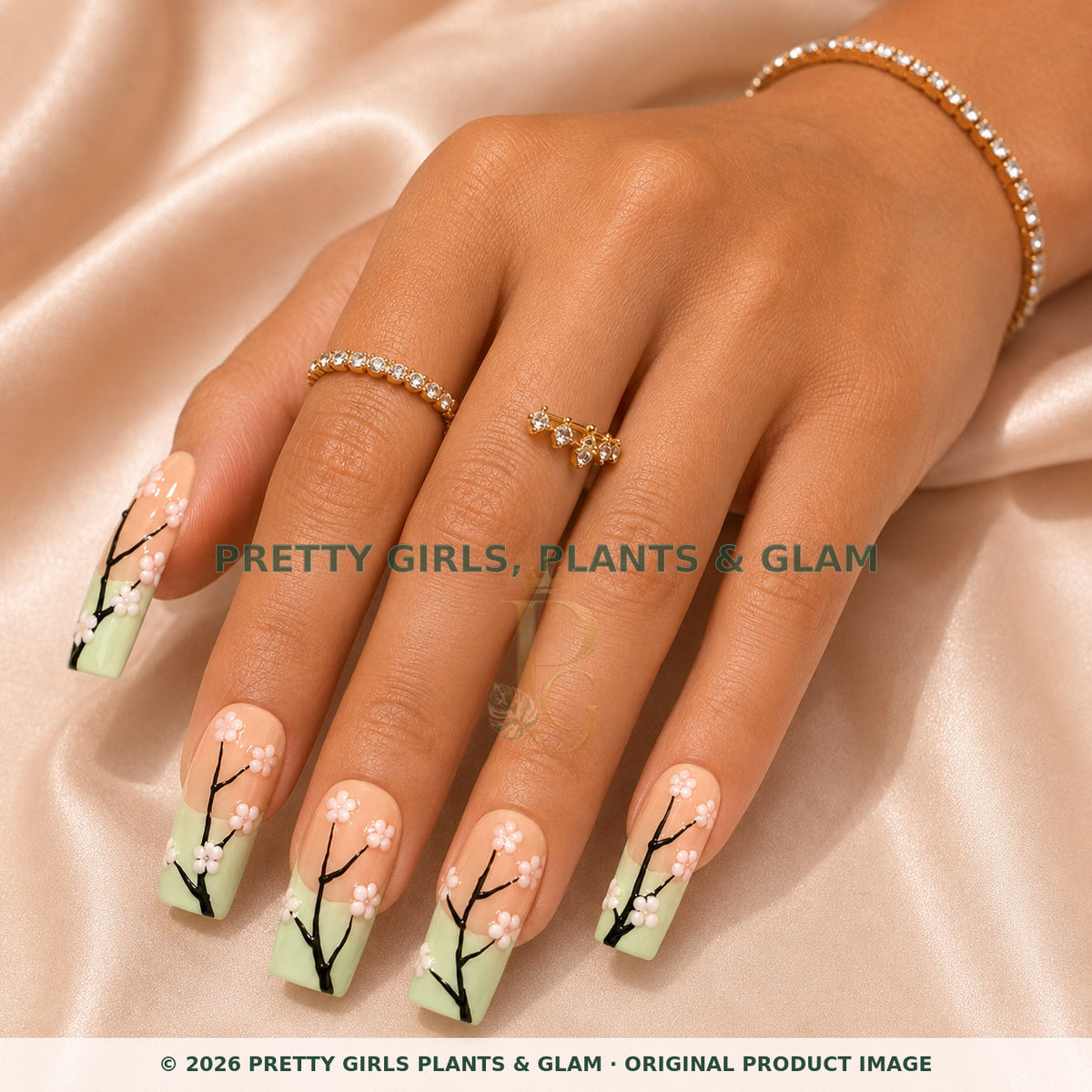 Mint Blossom press-on nails modeled on a hand