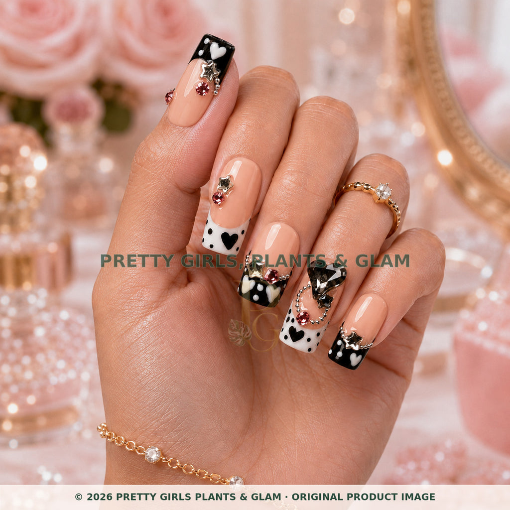 Noir Hearts press-on nails modeled upright on a hand
