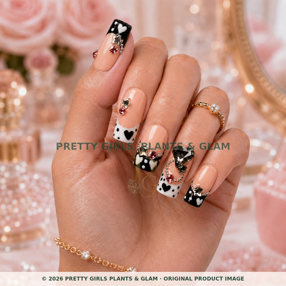 Noir Hearts press-on nails modeled upright on a hand