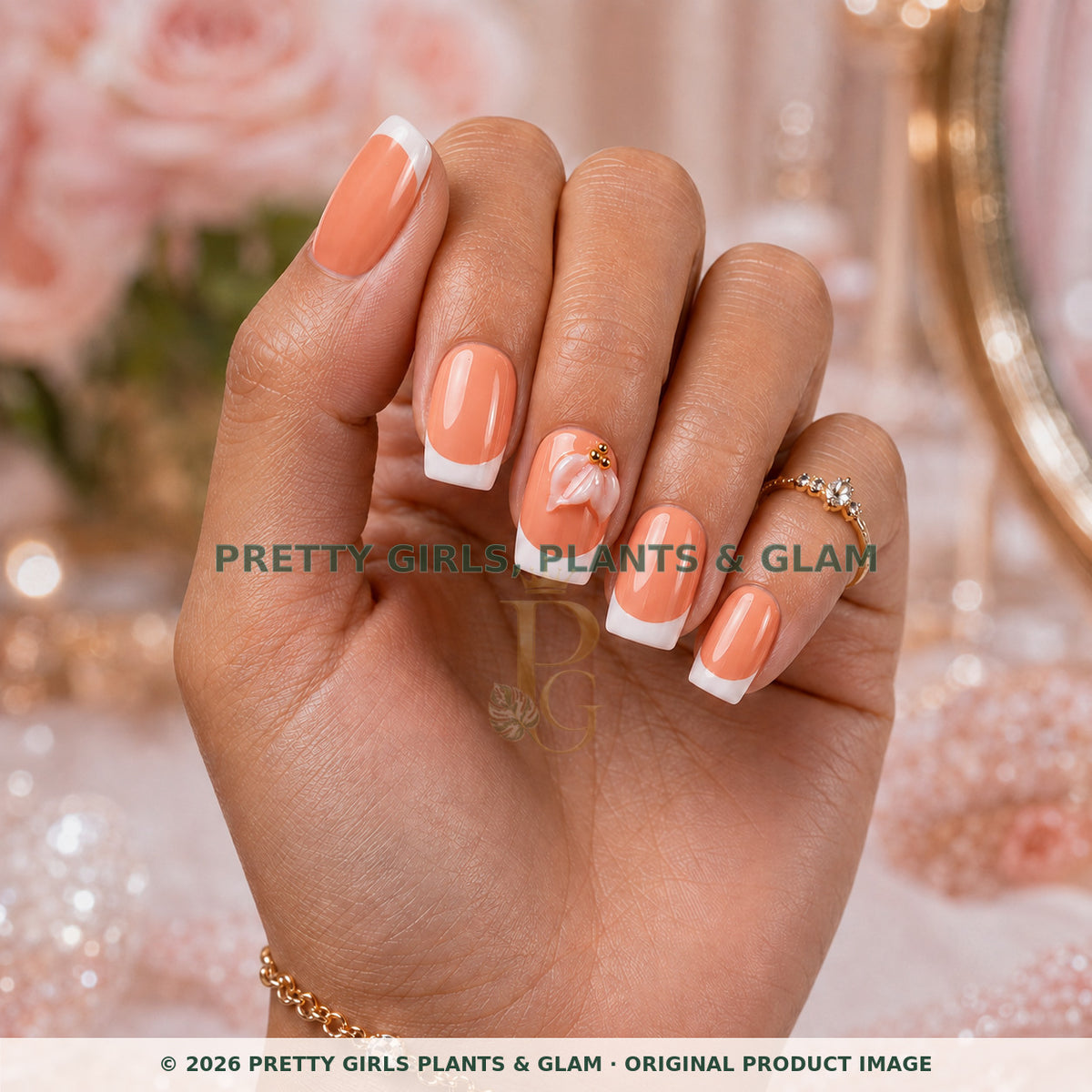 Peach Petal French press-on nails modeled upright on a hand
