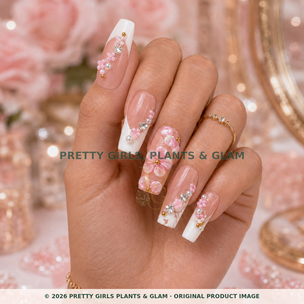 Pink Blossom press-on nails modeled upright on a hand