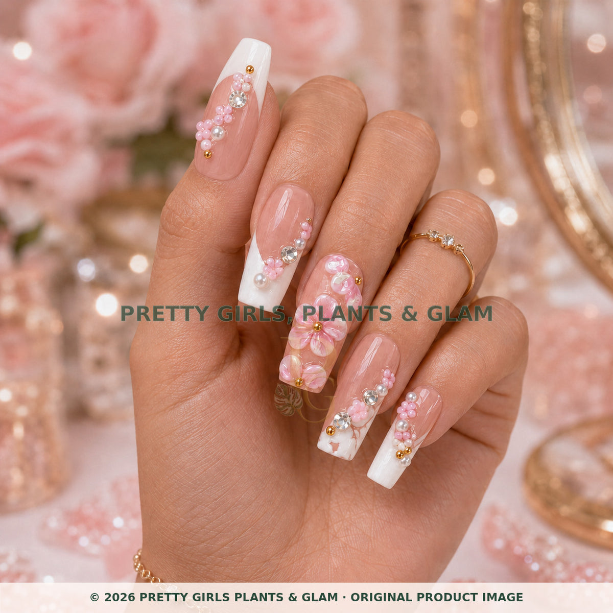Pink Blossom press-on nails modeled upright on a hand