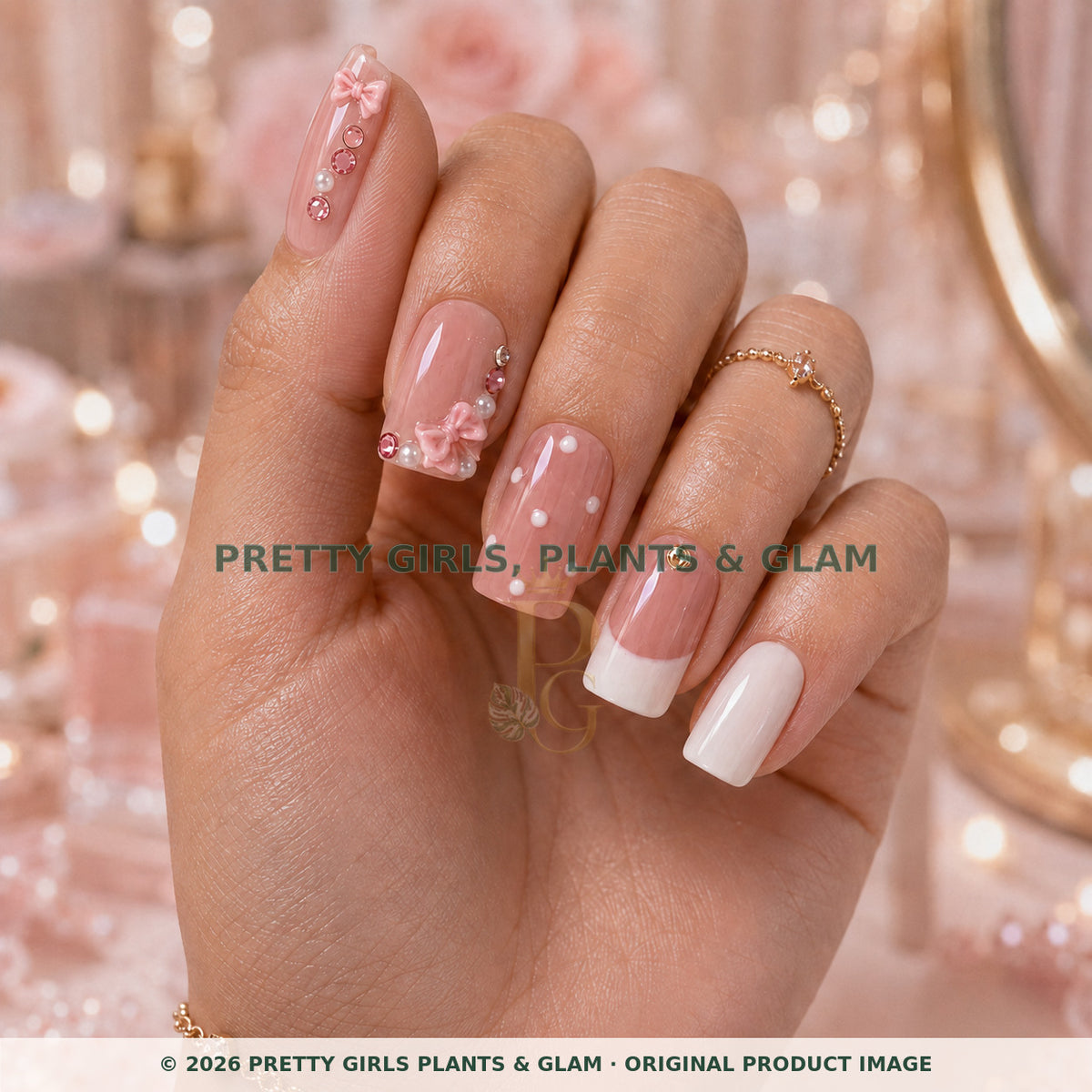 Pink Bow press-on nails modeled upright on a hand