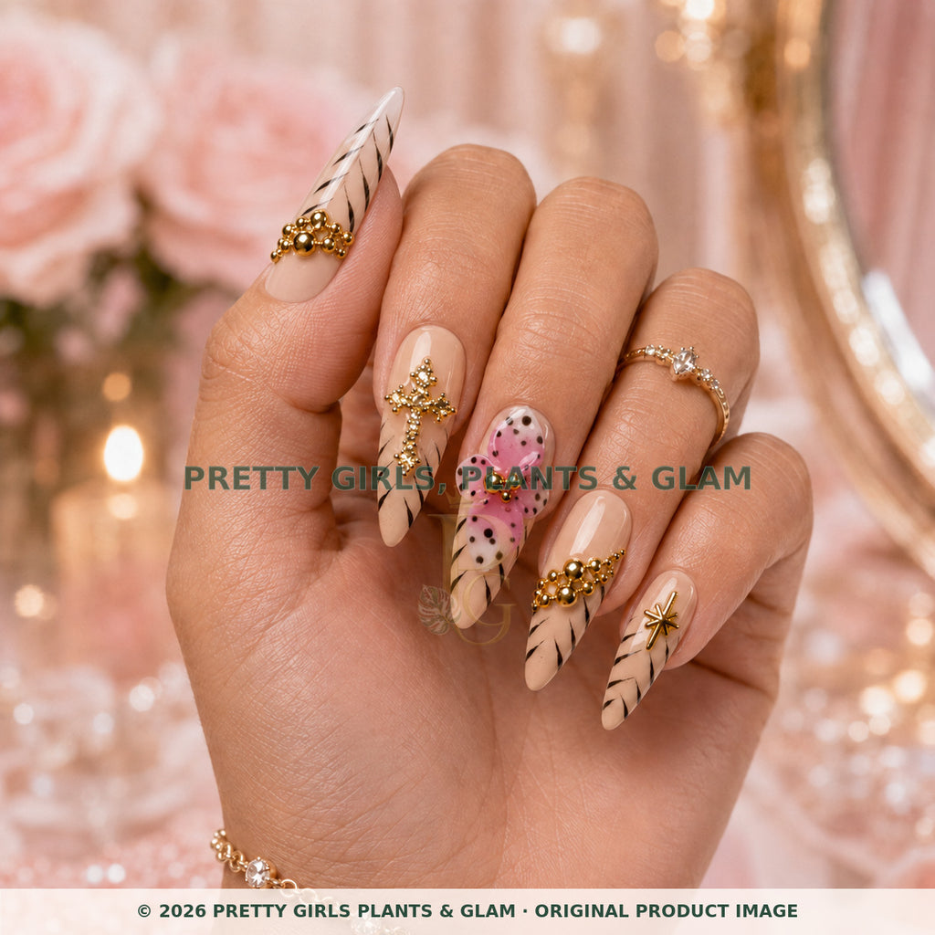 Pink Cross Bloom press-on nails modeled upright on a hand