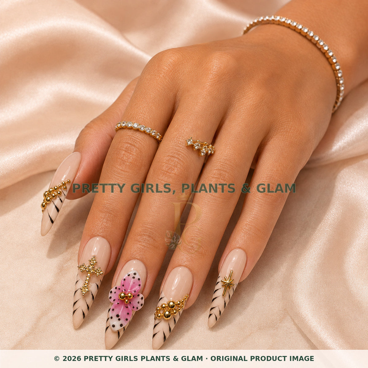 Pink Cross Bloom press-on nails modeled on a hand