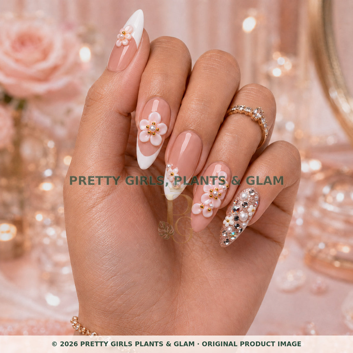 Pink Crystal Bloom press-on nails modeled upright on a hand