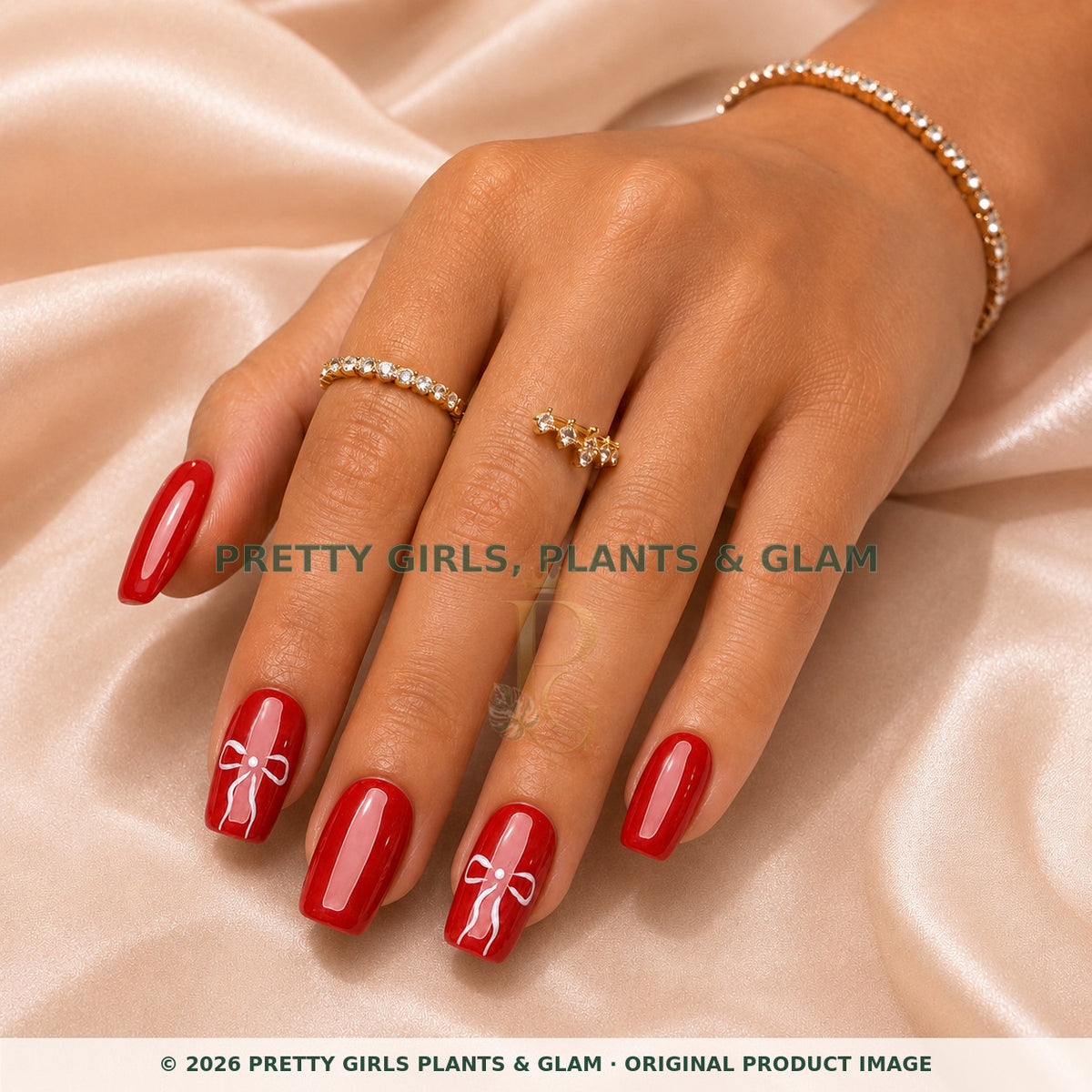 Red Ribbon press-on nails modeled on a hand