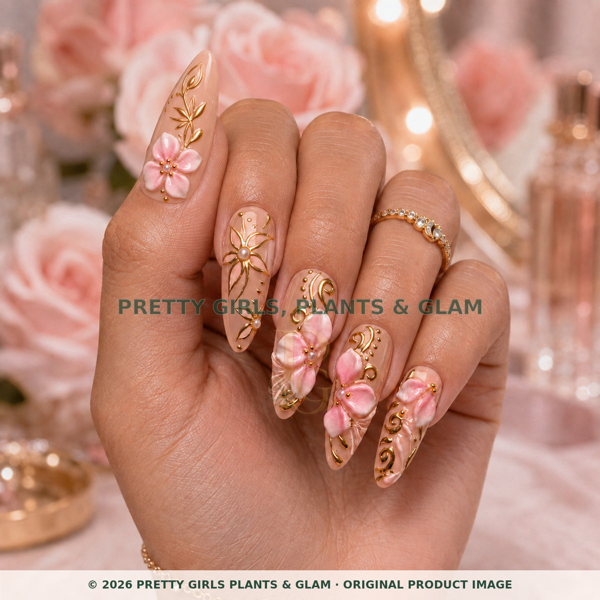 Rose Gold Bloom press-on nails modeled upright on a hand