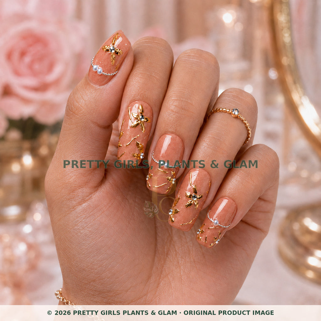 Rose Gold Vine press-on nails modeled upright on a hand
