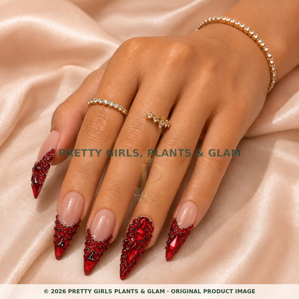 Ruby Romance press-on nails modeled on a hand