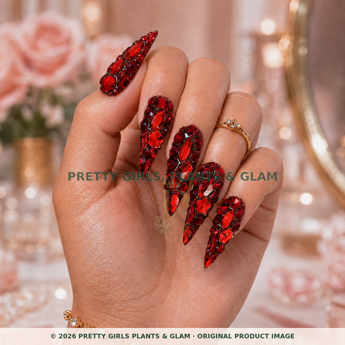Ruby Royale press-on nails modeled upright on a hand