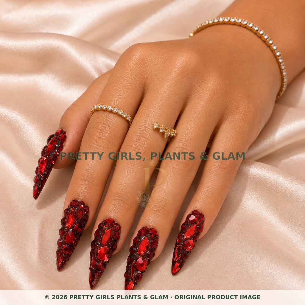 Ruby Royale press-on nails modeled on a hand