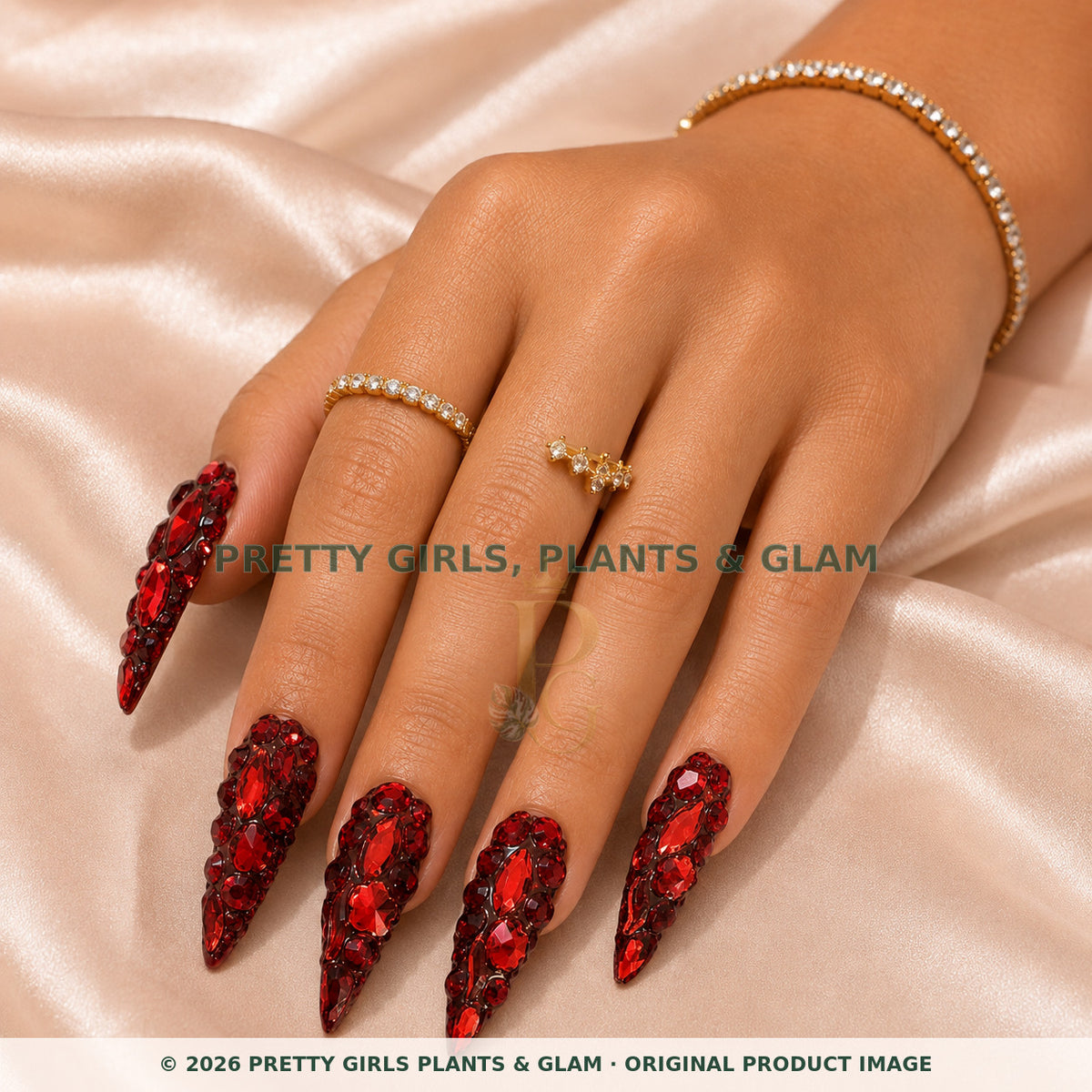 Ruby Royale press-on nails modeled on a hand