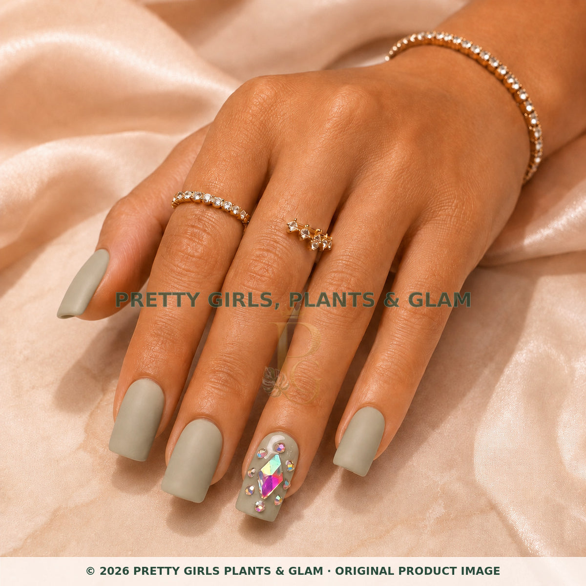 Sage Crystal press-on nails modeled on a hand