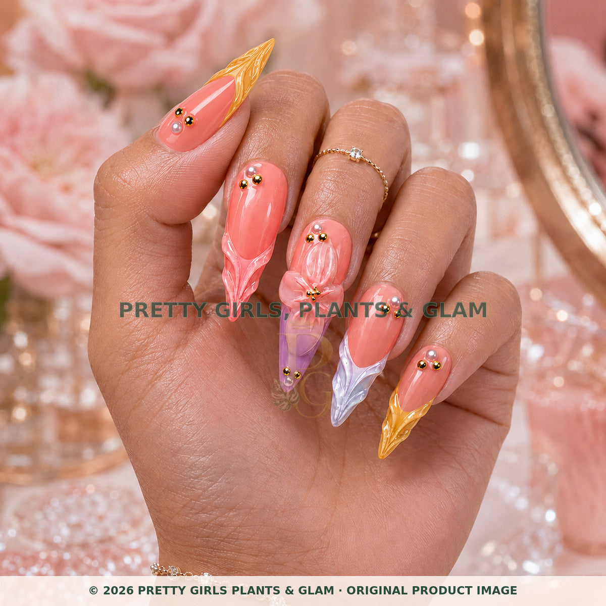 Sunset Petals press-on nails modeled upright on a hand