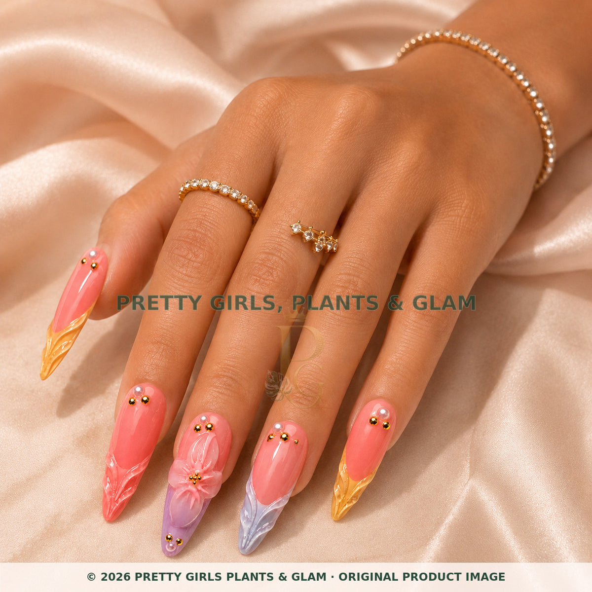 Sunset Petals press-on nails modeled on a hand